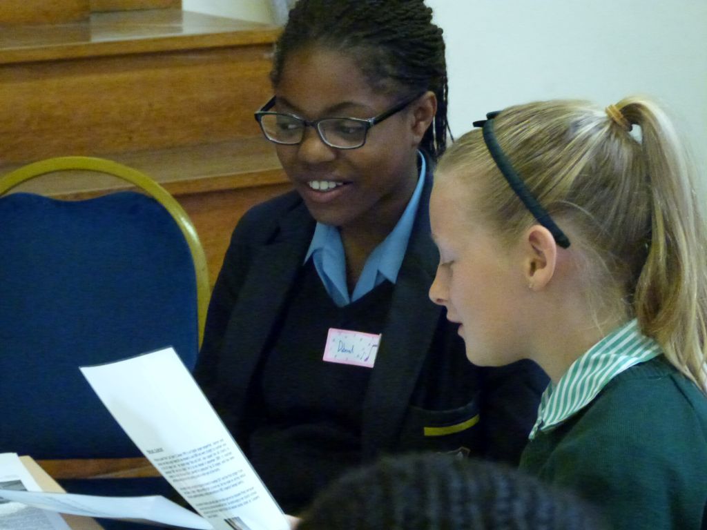 Students reviewing printed materials during a workshop