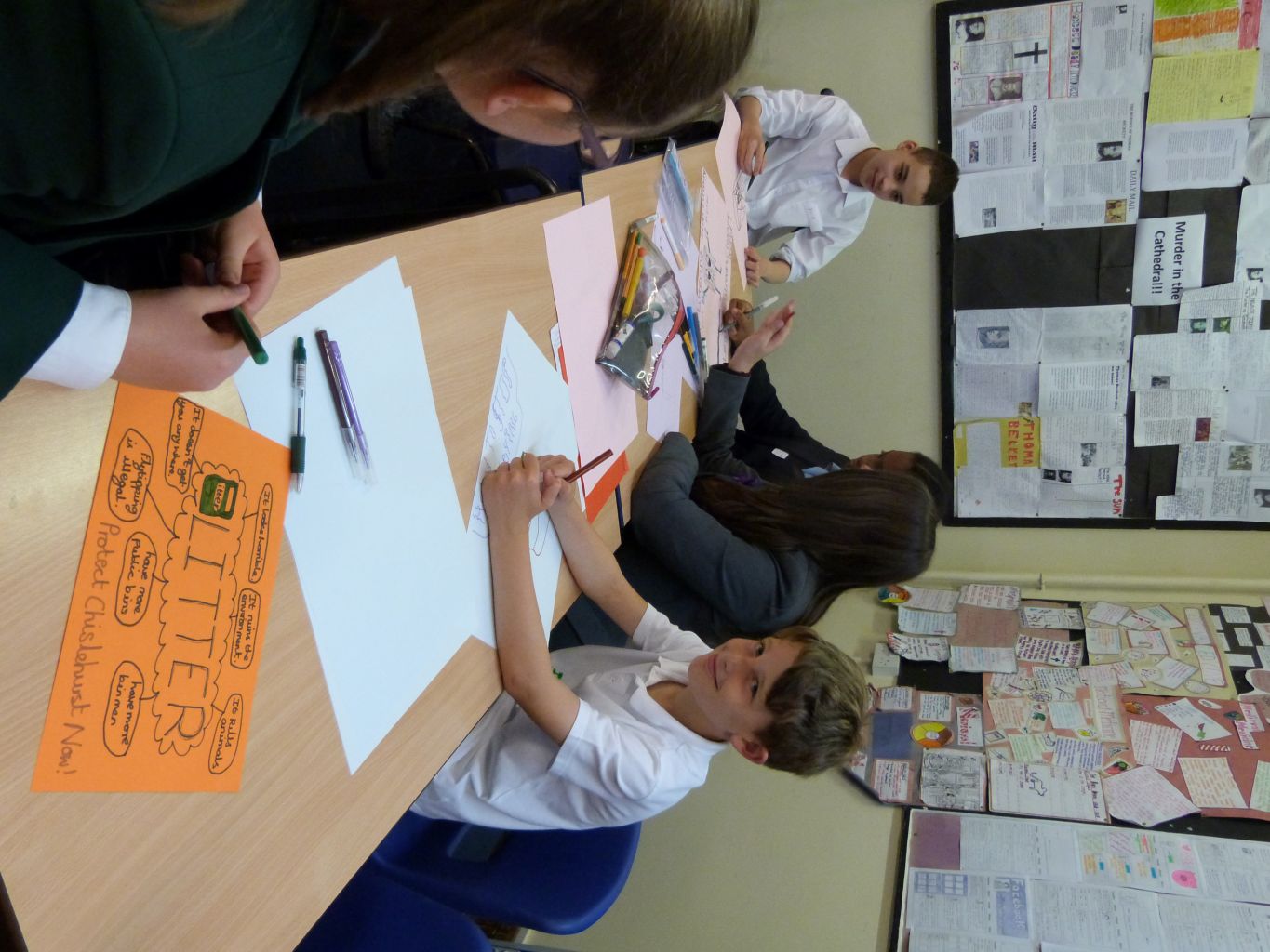 Students creating posters and project materials for environmental themes